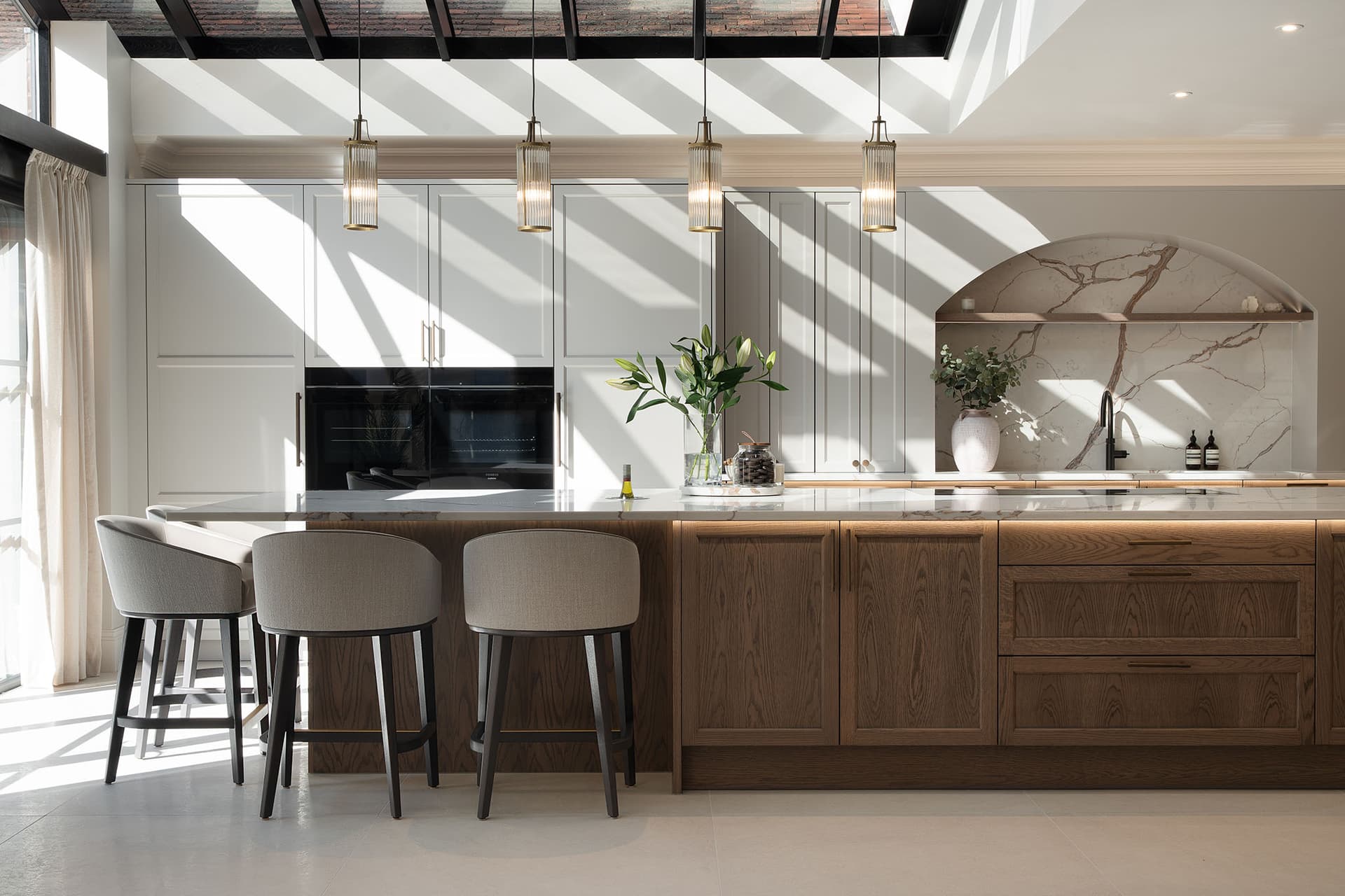 Luxury kitchen with oak island, marble backsplash and natural light